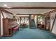Basement living space with a piano, a dining area, and a reading nook at 7001 S Newport St, Centennial, CO 80112