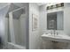 Charming bathroom with tub/shower combination and a beautiful pedestal sink at 7001 S Newport St, Centennial, CO 80112