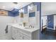 This dual vanity bathroom features matching mirrors and blue and white decor at 7001 S Newport St, Centennial, CO 80112