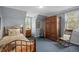 Guest bedroom with cozy rocking chair and bright, sunlit window at 7001 S Newport St, Centennial, CO 80112