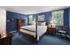 This cozy bedroom features navy walls, white trim, and a four-poster bed at 7001 S Newport St, Centennial, CO 80112