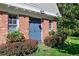 Close up of brick portion of home with colorful window boxes and lush shrubbery at 7001 S Newport St, Centennial, CO 80112