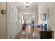 Elegant foyer with hardwood floors, decorative wallpaper, and a view into the living room at 7001 S Newport St, Centennial, CO 80112