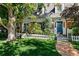 Charming two-story home featuring mature landscaping, brick walkway and white picket fence at 7001 S Newport St, Centennial, CO 80112