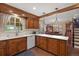 Kitchen with custom wood cabinetry, pendant lighting, and bar seating at 7001 S Newport St, Centennial, CO 80112