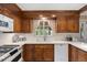 Bright kitchen features white countertops, stainless steel appliances, and custom wood cabinets at 7001 S Newport St, Centennial, CO 80112