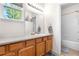 Bathroom features wood cabinets, granite counters, and a combination shower and tub at 22933 E Ontario Dr # 105, Aurora, CO 80016