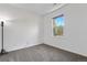 Bedroom with neutral walls and carpet, a floor lamp and a window providing natural light at 22933 E Ontario Dr # 105, Aurora, CO 80016