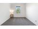Bedroom featuring neutral walls and carpet with a small table and window providing natural light at 22933 E Ontario Dr # 105, Aurora, CO 80016