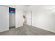 Bedroom with neutral walls and carpet with a sliding closet and doorway to other rooms at 22933 E Ontario Dr # 105, Aurora, CO 80016
