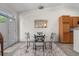 Bright dining area with glass table, wrought iron chairs, and a large window at 22933 E Ontario Dr # 105, Aurora, CO 80016