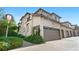 Stunning townhome showcases a two-car garage, lush greenery, and a welcoming front entrance at 22933 E Ontario Dr # 105, Aurora, CO 80016
