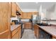 Well-equipped kitchen with stainless steel refrigerator and wooden cabinets at 22933 E Ontario Dr # 105, Aurora, CO 80016