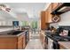Open kitchen view with black appliances and access to a dining area at 22933 E Ontario Dr # 105, Aurora, CO 80016