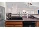 Functional kitchen area with wood cabinets, practical sink, and stainless steel refrigerator at 22933 E Ontario Dr # 105, Aurora, CO 80016