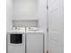 A neat laundry room is equipped with a modern washer, dryer, and functional shelving at 22933 E Ontario Dr # 105, Aurora, CO 80016