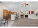 Open-concept living space with a cozy fireplace and seamless flow to the kitchen area and breakfast bar at 22933 E Ontario Dr # 105, Aurora, CO 80016