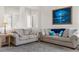 Comfortable living room with plush sofas, neutral walls, and a decorative painting at 22933 E Ontario Dr # 105, Aurora, CO 80016