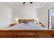 Spacious bedroom featuring a wooden bed frame and soft lighting at 22933 E Ontario Dr # 105, Aurora, CO 80016