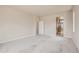 Spacious bedroom featuring neutral walls, carpet flooring, and a doorway to the bathroom at 2560 Lupton Ln, Lafayette, CO 80026