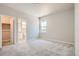 Bedroom featuring neutral walls, carpet, and doors to bathroom and closet space at 2560 Lupton Ln, Lafayette, CO 80026