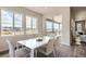 Bright dining room with large windows and sliding glass door access to outdoor deck at 2560 Lupton Ln, Lafayette, CO 80026