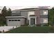 Two story home featuring gray siding, brick accents, an attached garage, and a well manicured lawn at 2560 Lupton Ln, Lafayette, CO 80026