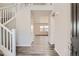 Inviting foyer with light walls, wood flooring, and an elegant staircase to the upper level at 2560 Lupton Ln, Lafayette, CO 80026
