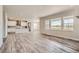 Spacious open-concept living room featuring modern flooring and abundant natural light at 2560 Lupton Ln, Lafayette, CO 80026
