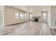 Bright living room with multiple windows, wood flooring, and a fireplace at 2560 Lupton Ln, Lafayette, CO 80026