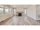Bright living room featuring a cozy fireplace with stone surround at 2560 Lupton Ln, Lafayette, CO 80026