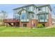 Back exterior of home showcases the walkout basement, architectural features, and manicured lawn at 3970 Pierson St, Wheat Ridge, CO 80033