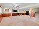 Finished basement with carpeted floors, wood accents, a TV, and storage cabinets at 3970 Pierson St, Wheat Ridge, CO 80033