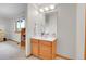 Cozy bathroom features wood vanity, great light and neutral tones at 3970 Pierson St, Wheat Ridge, CO 80033