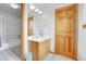 Traditional bathroom with a wood vanity, well-lit mirror and tiled shower/tub visible at 3970 Pierson St, Wheat Ridge, CO 80033