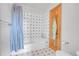 Bright bathroom with tub/shower combination and colorful tiled surround at 3970 Pierson St, Wheat Ridge, CO 80033