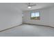 Bright bedroom with a ceiling fan, window with neighborhood views, and plush carpet at 3970 Pierson St, Wheat Ridge, CO 80033