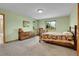 Comfortable bedroom with carpeted floors and natural light, featuring classic wood furnishings at 3970 Pierson St, Wheat Ridge, CO 80033