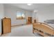 Bright bedroom with neutral carpet features natural light and classic wood furnishings at 3970 Pierson St, Wheat Ridge, CO 80033