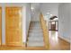 Sunlit entryway with wood floors and staircase leads to a spacious living area at 3970 Pierson St, Wheat Ridge, CO 80033