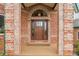 Close-up of a brick front door entrance with decorative glass and light fixtures at 3970 Pierson St, Wheat Ridge, CO 80033
