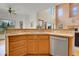 Kitchen sink with wooden cabinets and stainless steel dishwasher at 3970 Pierson St, Wheat Ridge, CO 80033