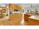 Bright kitchen with wooden cabinets, tile countertops, and hardwood floors at 3970 Pierson St, Wheat Ridge, CO 80033