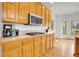 Kitchen with gas range, wooden cabinets, and hardwood floors at 3970 Pierson St, Wheat Ridge, CO 80033