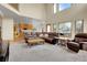 Bright living room with high ceilings, large windows, a brick fireplace and plush seating at 3970 Pierson St, Wheat Ridge, CO 80033
