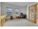 Office with windows, carpeted floors, and a glass panel door at 3970 Pierson St, Wheat Ridge, CO 80033