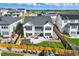 Beautiful backyard with a concrete patio, stairs, lush grass, and a wooden fence, with scenic neighborhood views at 6456 Kenzie Cir, Castle Pines, CO 80108