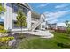 Beautiful two-story home featuring backyard with concrete patio, green grass, and white stairs leading to upper deck at 6456 Kenzie Cir, Castle Pines, CO 80108