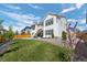 Beautiful backyard with a lush green lawn, well-maintained landscaping, and a charming white exterior at 6456 Kenzie Cir, Castle Pines, CO 80108