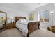 Inviting bedroom featuring a wooden bed frame, soft bedding, and ample natural light at 6456 Kenzie Cir, Castle Pines, CO 80108